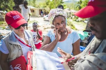 Prosper global employees work with haitian woman