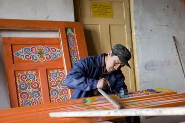 A worker making furniture.