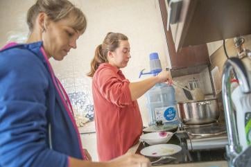 September 2023, mykolaiv, ukraine. olena (33, blue shirt) and oleksandra (28, red shirt) cook in the kitchen at a shelter run by prosper global partner organization perspectyva. 