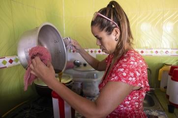 Windey prepares her coffee cart for the day, building a business and a future for her family with support from prosper global.