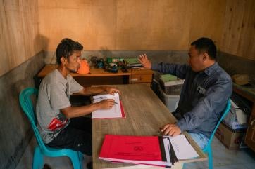 In a nearby village in sigi regency, marwan meets with a community leader to support disaster preparedness for the area.