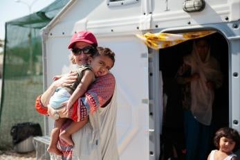 Prosper global employee holding a young child