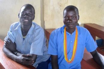 Okidi and akanyo sitting side by side