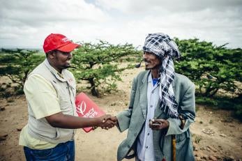 Prosper global employee shaking hands with man in ethiopia