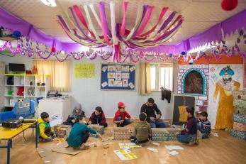 Mohammad enjoys learning about syrian culture. here, he makes a house out of cardboard, decorating it with what he’s learnt about syrian traditions, art and values.