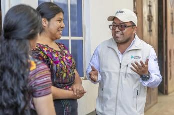 Member of prosper global's guatemalan team speaks with community members.