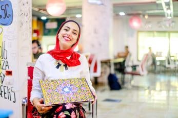 Eman, a freelance medical translator and graduate of Prosper Global's Gaza Sky Geeks freelance training, with her laptop