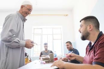 Hayder Shalash Aboudi, 62, receives a cash distribution from Prosper Global. 