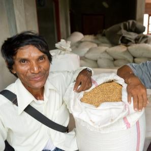Kyi, pictured left, with a bag of rice