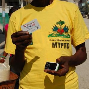 Man holding mobile phone and cash card