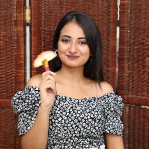 A person holding a makeup brush.
