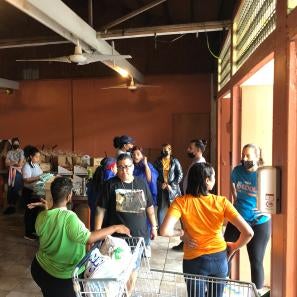In cataño, puerto rico, volunteers at association pro juventud y comunidad de barrio palmas, a prosper global resilience hub, prepare supplies for distribution. 