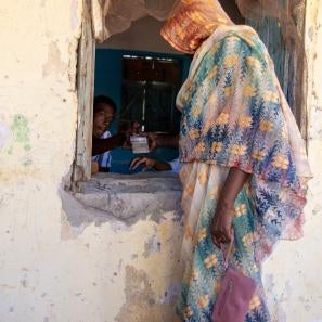 A person handing another cash through a window.