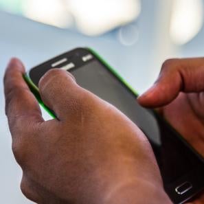 Hands using a mobile phone.
