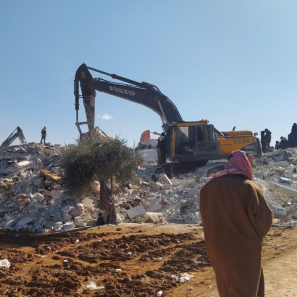 Earthquake responders working with debris.