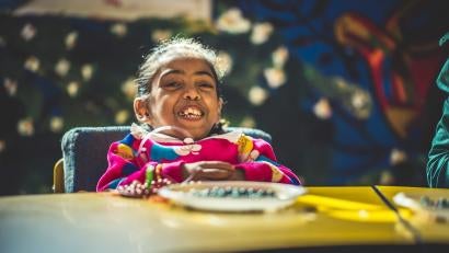Recreational activities for the class, like beading, help foster acceptance and prevent any discrimination Malak might face for being different. They also provide additional physical exercise, which helps meet her needs without stigmatizing her.