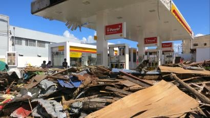 Scraps of sticks, plywood and tree branches blockade a damaged gas station. Scenes like this covered Tacloban, a formerly lively city of 220,000 people.