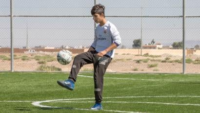 The soccer, weightlifting and other physical activities held at the child-friendly spaces help young refugees like Islam, 15, and Yousef, 15, expel stress and energy. Photo: Ezra Millstein/Prosper Global