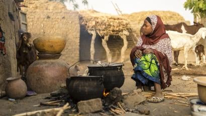 9:07 a.m. — Most of Badariya’s morning is spent cooking with her mother: finding wood, tending the fire and stirring the grains. “I also take some food to my grandmother, who is blind and can’t see,” she explains.