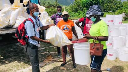A L’Asile resident picks up a kit of essential supplies. Our next step is to distribute cash assistance to thousands of families so they can purchase what they need most.