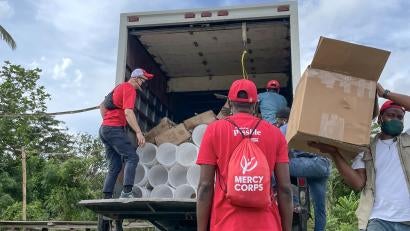 Our team unloads a truck of supplies for distribution in L’Asile. The supply kits include water purification tablets, soap, diapers, mosquito nets, tarps, and more.