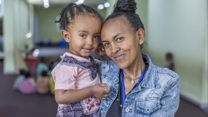 Ethiopian mother and daughter smiling together.