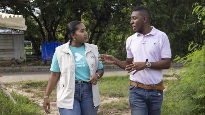 Prosper global employee speaks with community members.