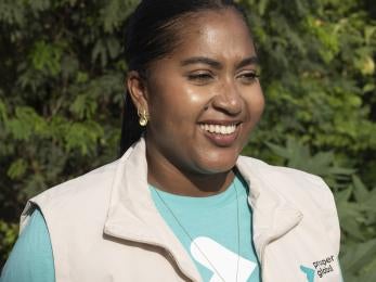 Prosper Global employee smiling outside.