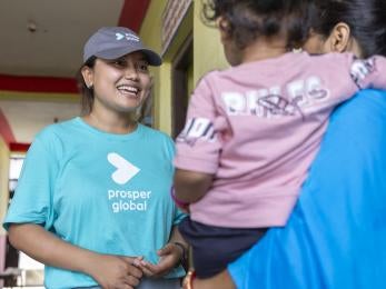Member of Prosper Global's Nepalese team meets with community members.